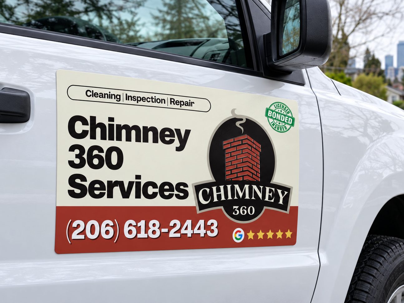 A Chimney 360 magnet on the door of a white service truck, with the Seattle skyline behind it